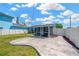 View of the backyard with a screened-in patio, a door to the house, and a patio with concrete pavers at 5367 5Th N Ave, St Petersburg, FL 33710