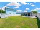 Large grassy backyard featuring a privacy fence, a tool shed, and a view of the back of the house at 5367 5Th N Ave, St Petersburg, FL 33710