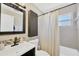 Cozy bathroom with tile shower and tile backsplash above sink at 5367 5Th N Ave, St Petersburg, FL 33710