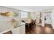 Charming dining area with a wooden table, granite countertop bar, and a view of the laundry area at 5367 5Th N Ave, St Petersburg, FL 33710