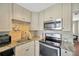 Kitchen with stainless steel appliances, granite countertops, and tile backsplash at 5367 5Th N Ave, St Petersburg, FL 33710