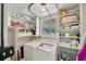 Well-organized laundry room with washer, dryer and storage shelves at 5367 5Th N Ave, St Petersburg, FL 33710