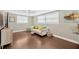 Comfortable living room showcasing hardwood floors, a couch, and large bright windows at 5367 5Th N Ave, St Petersburg, FL 33710