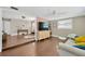 Open-concept living area with hardwood floors and a modern couch, seamlessly connected to other spaces at 5367 5Th N Ave, St Petersburg, FL 33710