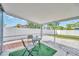 View of the screened patio with a table, two chairs, and artificial turf, perfect for relaxing or entertaining at 5367 5Th N Ave, St Petersburg, FL 33710