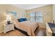 Cozy bedroom with wood flooring, a comfortable bed, and natural light from the window at 6021 Bahia Del Mar Cir # 534, St Petersburg, FL 33715