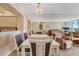 Elegant dining area with seating for six, stylish lighting, and an open view into the living room at 6021 Bahia Del Mar Cir # 534, St Petersburg, FL 33715