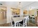 Bright dining room featuring white table and chairs, chandelier and view to living area at 6021 Bahia Del Mar Cir # 534, St Petersburg, FL 33715