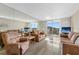 Bright living room with comfortable seating, tile floors, and access to a scenic balcony at 6021 Bahia Del Mar Cir # 534, St Petersburg, FL 33715