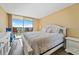 Main bedroom featuring king-size bed, slider to balcony, and views of the water at 6021 Bahia Del Mar Cir # 534, St Petersburg, FL 33715