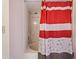 Bathroom shower featuring a tub, shower head, and a red patterned shower curtain at 6021 Bahia Del Mar Cir # 534, St Petersburg, FL 33715