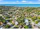 Aerial view showcasing the community and the blue water in the distance with clear skies and sunny day at 715 Charlotte Ave, Tarpon Springs, FL 34689