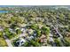 Birds-eye view featuring homes, lush greenery, and a community pool at 715 Charlotte Ave, Tarpon Springs, FL 34689