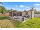 This home has a spacious backyard with a screened in patio and a lovely area for seating and grilling at 715 Charlotte Ave, Tarpon Springs, FL 34689