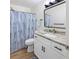 Bright bathroom with marble countertop, modern fixtures, stylish shower curtain, and a vanity at 715 Charlotte Ave, Tarpon Springs, FL 34689