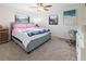 Comfortable bedroom featuring plush carpeting, a ceiling fan, and two windows that allow in natural light at 715 Charlotte Ave, Tarpon Springs, FL 34689