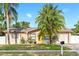 Beautiful home featuring a well-maintained lawn, attractive landscaping, and inviting curb appeal at 715 Charlotte Ave, Tarpon Springs, FL 34689