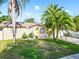 This home has great curb appeal with beautiful mature trees, flowerbeds, and a well maintained lawn at 715 Charlotte Ave, Tarpon Springs, FL 34689