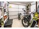 Garage interior with storage shelves, tools, and an electric motorcycle at 715 Charlotte Ave, Tarpon Springs, FL 34689