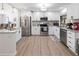 Bright kitchen featuring white cabinets, stainless steel appliances, and granite countertops, with modern updates at 715 Charlotte Ave, Tarpon Springs, FL 34689