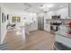 Well-lit kitchen featuring stainless steel appliances, light granite countertops, and an open layout with an adjacent seating area at 715 Charlotte Ave, Tarpon Springs, FL 34689