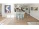 Open-concept living area with wood-look floors that connect the kitchen and dining, perfect for entertaining at 715 Charlotte Ave, Tarpon Springs, FL 34689