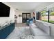 Well-lit living room features a large window, comfortable sofa, stylish rug, and modern decor for a relaxing atmosphere at 715 Charlotte Ave, Tarpon Springs, FL 34689