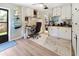 Office space featuring built-in shelving and storage, a desk area, and a view into the walk-in closet at 715 Charlotte Ave, Tarpon Springs, FL 34689