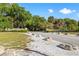 Stone signage at Fred H. Howard Park's entrance, surrounded by nature at 715 Charlotte Ave, Tarpon Springs, FL 34689