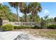 A decorative stone sign for Fred H. Howard Park with palm trees nearby at 715 Charlotte Ave, Tarpon Springs, FL 34689