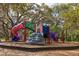 A colorful playground with slides and climbing structures in a park setting at 715 Charlotte Ave, Tarpon Springs, FL 34689