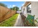 Side yard view of the home showing an outdoor AC unit and nice landscaping adjacent to the home at 715 Charlotte Ave, Tarpon Springs, FL 34689