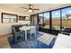 Cozy sunroom with tiled floor, ceiling fan, dining table set, a sofa, and large windows offering views of the backyard at 715 Charlotte Ave, Tarpon Springs, FL 34689