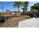 A backyard featuring a picnic table, palm trees, and a shed, perfect for outdoor enjoyment at 721 75Th N Ave, St Petersburg, FL 33702