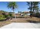 A backyard featuring a picnic table, palm trees, and a shed, perfect for outdoor enjoyment at 721 75Th N Ave, St Petersburg, FL 33702