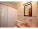 Bathroom with pink tile and retro sink, featuring a shower with curtain at 721 75Th N Ave, St Petersburg, FL 33702