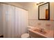 Bathroom with pink tile and retro sink, featuring a shower with curtain at 721 75Th N Ave, St Petersburg, FL 33702