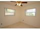 Cozy bedroom featuring two windows, neutral walls, and speckled carpet at 721 75Th N Ave, St Petersburg, FL 33702