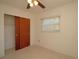 Comfortable bedroom with speckled carpet, closet with sliding doors, and a window at 721 75Th N Ave, St Petersburg, FL 33702