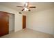 Bedroom with a ceiling fan, closet, and wood door at 721 75Th N Ave, St Petersburg, FL 33702