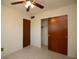 Bedroom with dual closets, ceiling fan, and neutral carpet at 721 75Th N Ave, St Petersburg, FL 33702