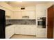 Charming kitchen featuring all white cabinetry, stainless steel appliances and mosaic tile backsplash at 721 75Th N Ave, St Petersburg, FL 33702
