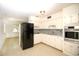 Bright kitchen featuring all white cabinets, modern stainless appliances and mosaic tile backsplash at 721 75Th N Ave, St Petersburg, FL 33702