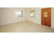 Neutral living room with lots of natural light featuring a decorative door at 721 75Th N Ave, St Petersburg, FL 33702