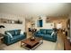 Staged living room featuring two sofas and decor with open access to the dining area at 721 75Th N Ave, St Petersburg, FL 33702