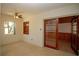 Bright living room with ceiling fan, window, and sliding glass doors to an outdoor space at 721 75Th N Ave, St Petersburg, FL 33702