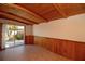 Bright sunroom with tiled flooring, wood paneled wainscoting and exposed rafters at 721 75Th N Ave, St Petersburg, FL 33702