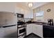 Efficient kitchen featuring stainless steel appliances, laminate counters, and crisp white cabinets at 750 Burlington N Ave # 4L, St Petersburg, FL 33701