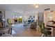 Open-concept living room with natural light, contemporary furnishings, and sliding door to a screened balcony at 750 Burlington N Ave # 4L, St Petersburg, FL 33701