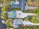 An aerial view of the property showcasing the pool, driveway, and surrounding landscape at 7500 N Ola Ave, Tampa, FL 33604